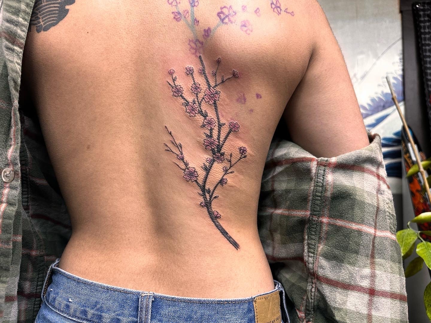 Cherry blossom tattoo along spine