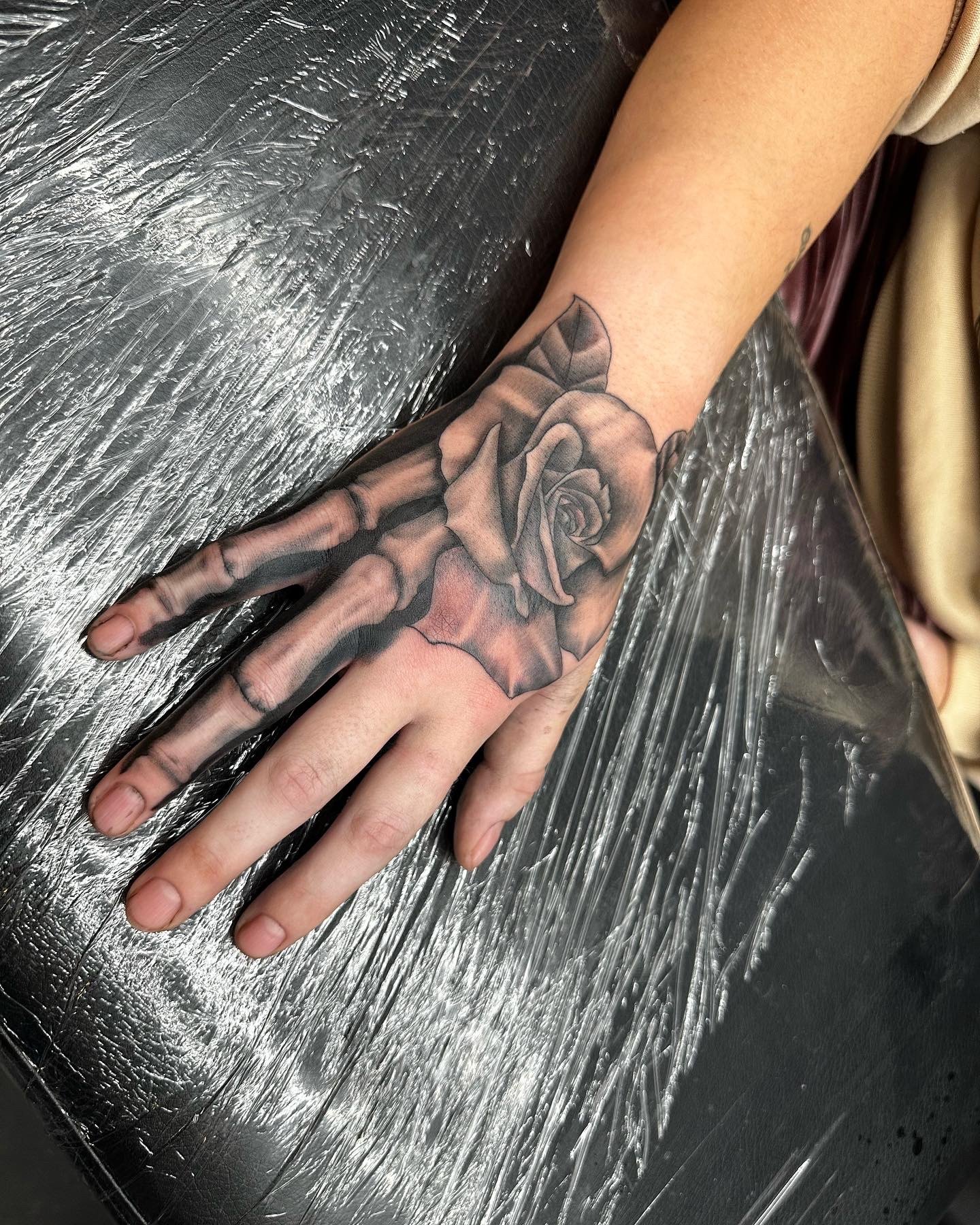 Rose tattoo on hand