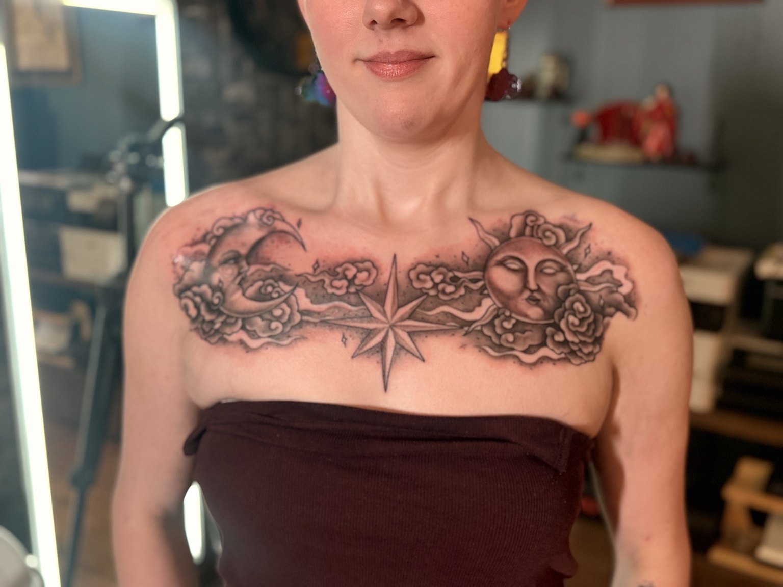 Sun and moon chest tattoo